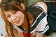 A young woman in a school uniform posing for a picture.