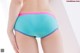 A woman wearing a blue and pink panties.