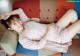 A woman laying on a colorful couch with her legs crossed.