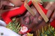 A black man with a santa claus hat on his head.