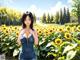 A woman standing in a field of sunflowers.